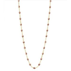 The Classic Gigi necklace features 18 carat gold, and sparkly copper